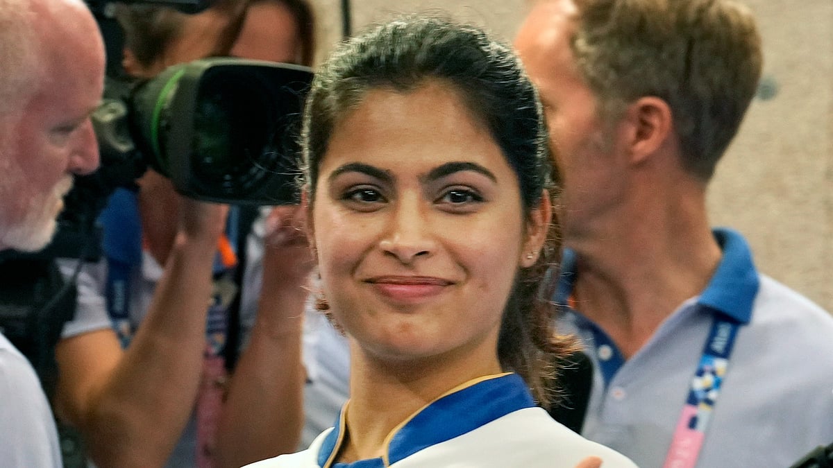 India's Manu Bhaker gestures after winning the bronze medal in the 10m air pistol mixed team event with Sarabjot Singh at the 2024 Summer Olympics, Tuesday, July 30, 2024, in Chateauroux, France.  - (AP Photo/Manish Swarup)